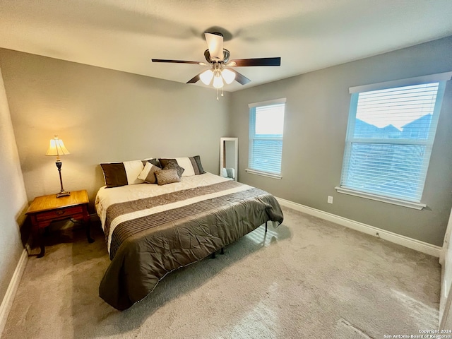 carpeted bedroom with ceiling fan