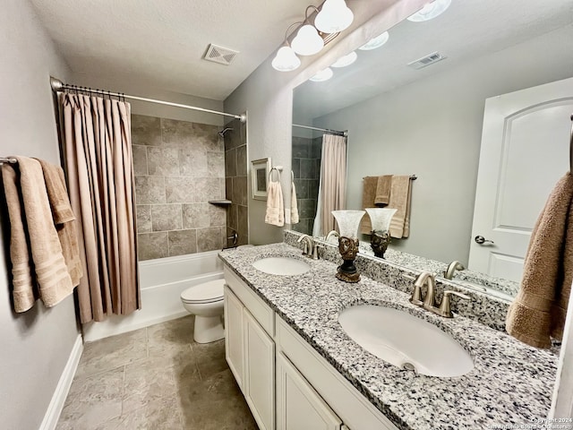 full bathroom with vanity, toilet, a textured ceiling, and shower / tub combo with curtain