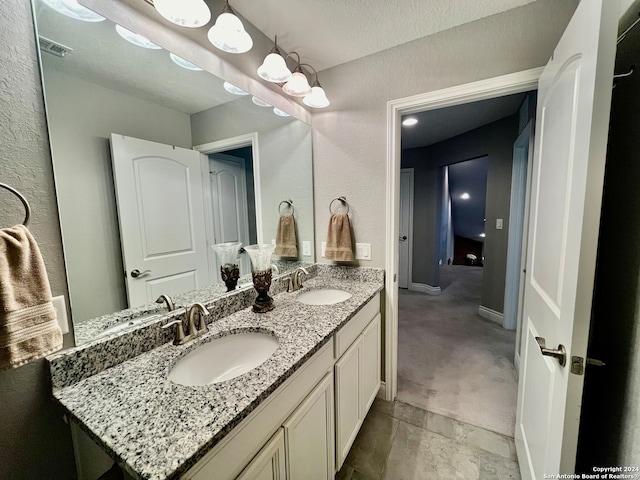 bathroom featuring vanity and a textured ceiling