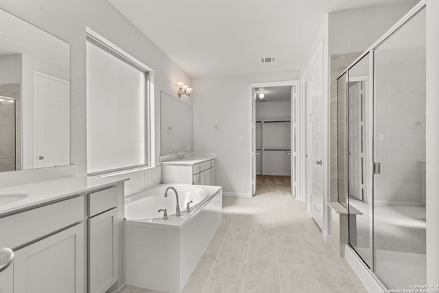 bathroom featuring plus walk in shower and vanity