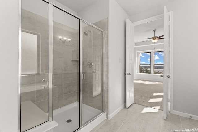 bathroom featuring tile patterned flooring, a shower with door, and ceiling fan