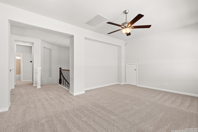 carpeted spare room featuring ceiling fan