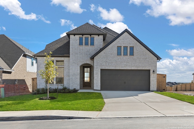 view of front facade featuring a front yard and a garage