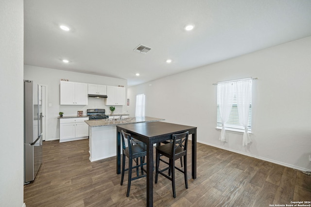 dining room with sink and dark wood-type flooring