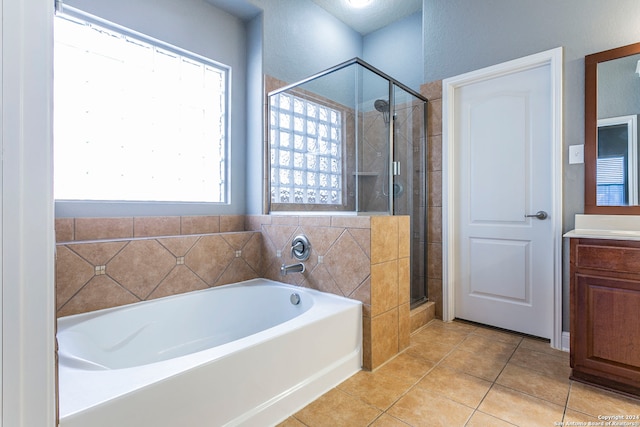 bathroom featuring vanity, tile patterned floors, and plus walk in shower