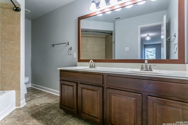 full bathroom with toilet, vanity, tile patterned floors, and washtub / shower combination