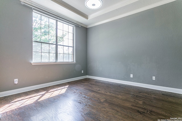 unfurnished room featuring ornamental molding and dark wood-type flooring