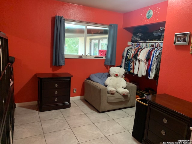 tiled bedroom featuring a closet