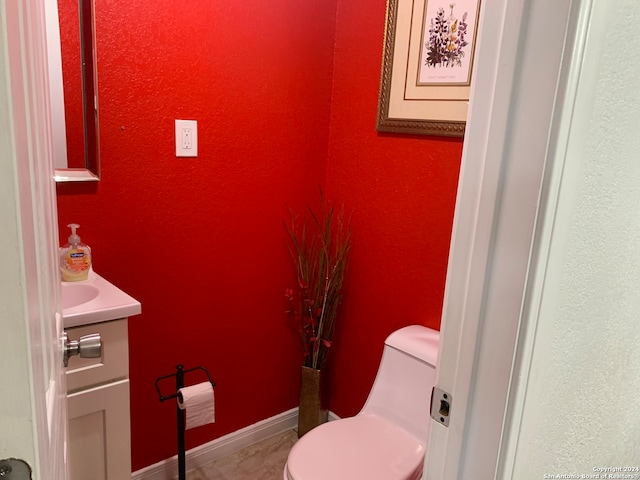 bathroom featuring toilet and vanity