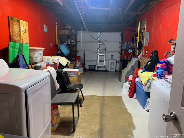 garage featuring electric panel and washer / clothes dryer