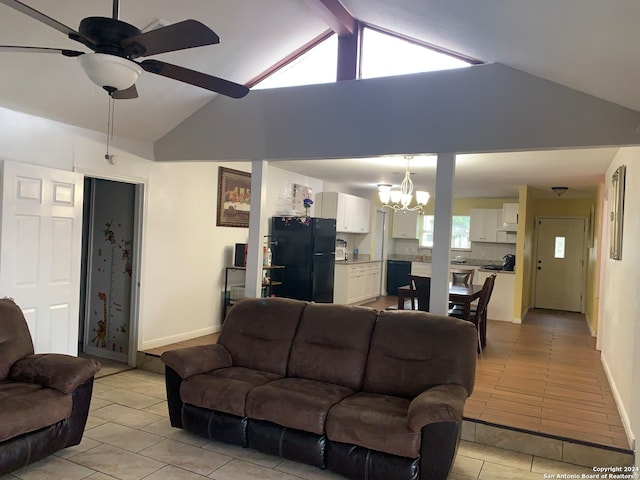 tiled living room with plenty of natural light, lofted ceiling with beams, and ceiling fan with notable chandelier