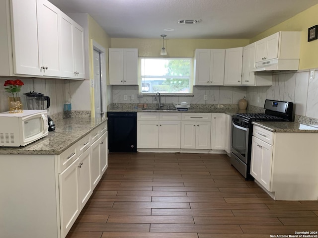 kitchen featuring a sink, visible vents, white microwave, gas range, and dishwasher