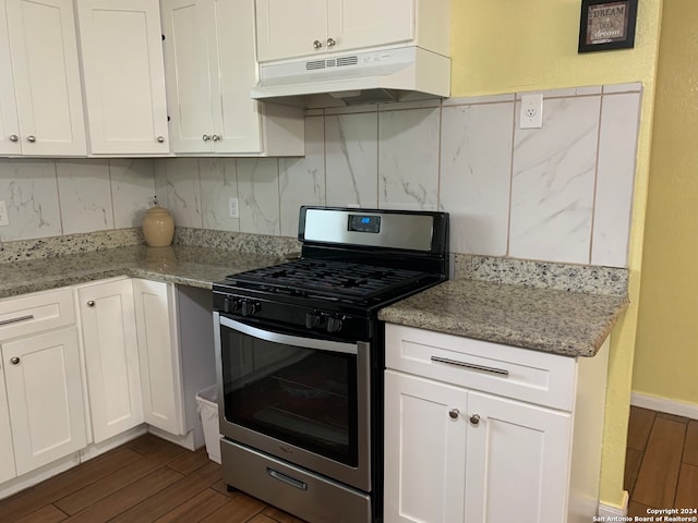 kitchen with stainless steel range with gas cooktop, light stone countertops, tasteful backsplash, and dark hardwood / wood-style flooring