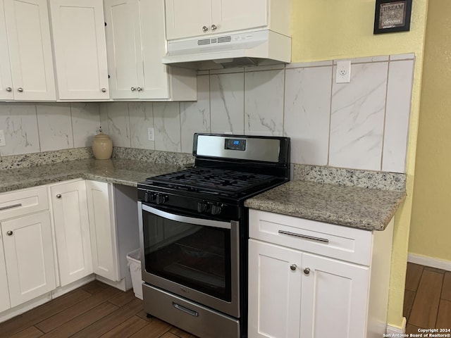 kitchen featuring white cabinets, stainless steel range with gas stovetop, dark wood-style floors, and under cabinet range hood