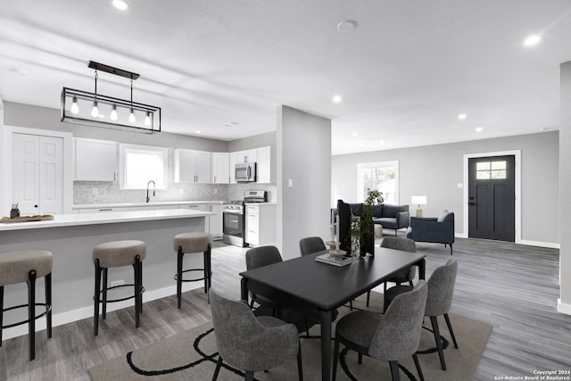 dining room with a textured ceiling and wood-type flooring