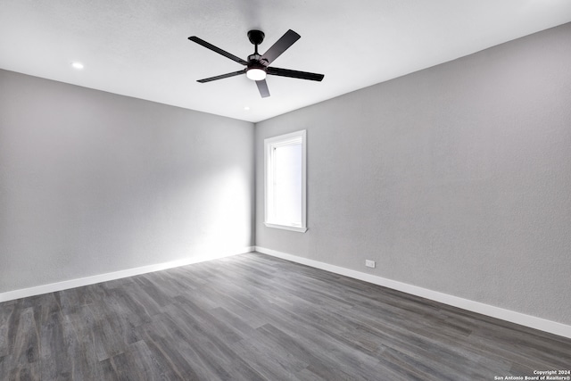 empty room with ceiling fan and dark hardwood / wood-style floors