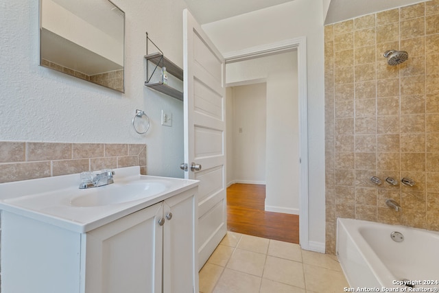 bathroom featuring vanity, tiled shower / bath combo, and tile patterned floors