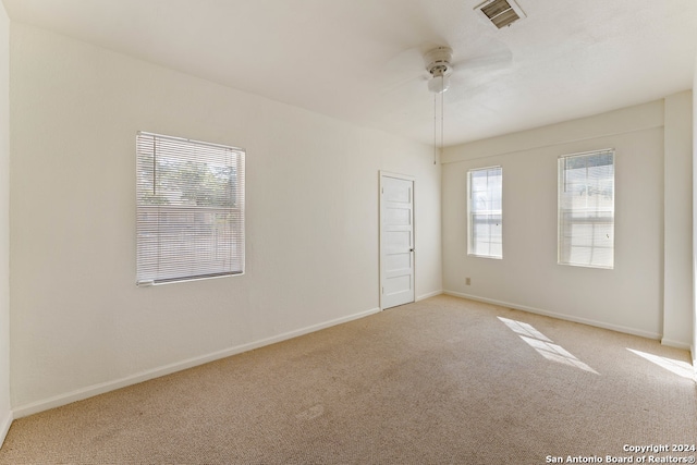 empty room with light carpet and ceiling fan