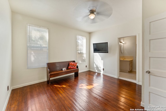 sitting room featuring a healthy amount of sunlight, dark wood-type flooring, and ceiling fan