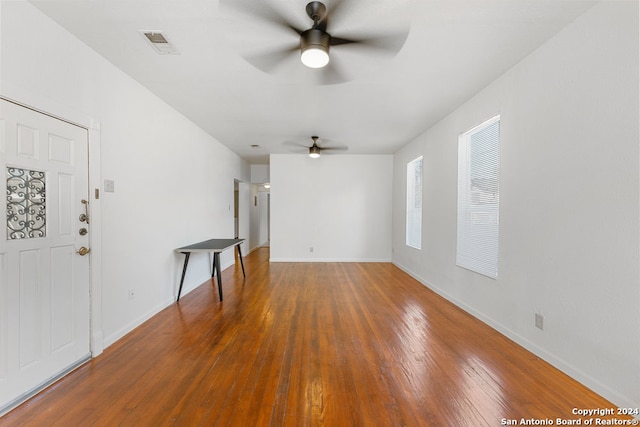 unfurnished living room featuring ceiling fan and hardwood / wood-style floors