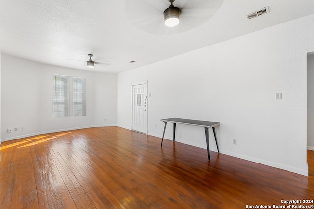 unfurnished room featuring a textured ceiling, wood-type flooring, and ceiling fan