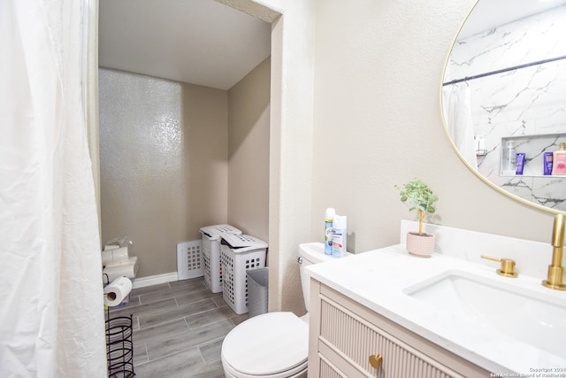 bathroom with vanity, hardwood / wood-style floors, and toilet