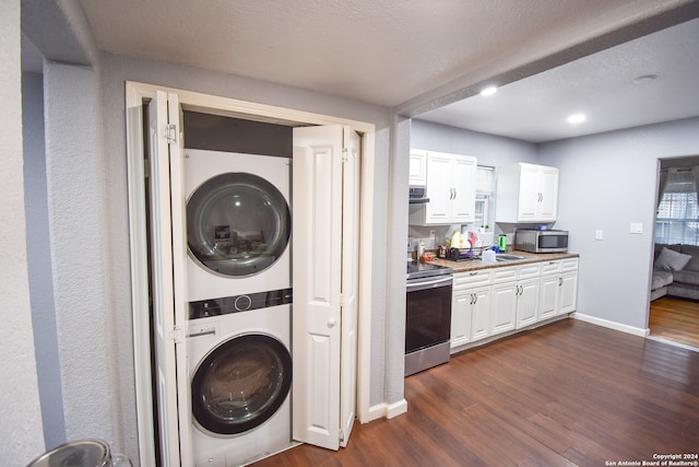 laundry area featuring sink, stacked washer / dryer, and dark hardwood / wood-style floors