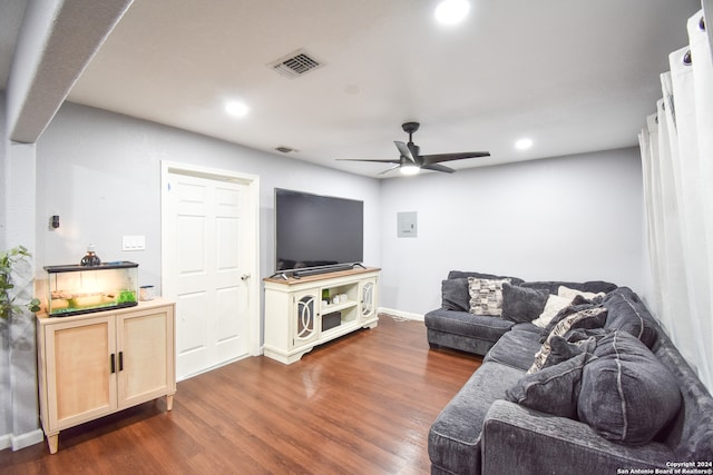 living room with dark wood-type flooring and ceiling fan