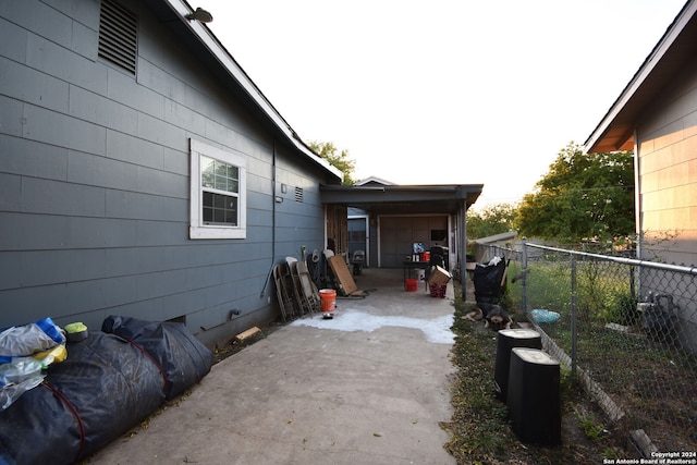 view of side of property with a patio and a carport