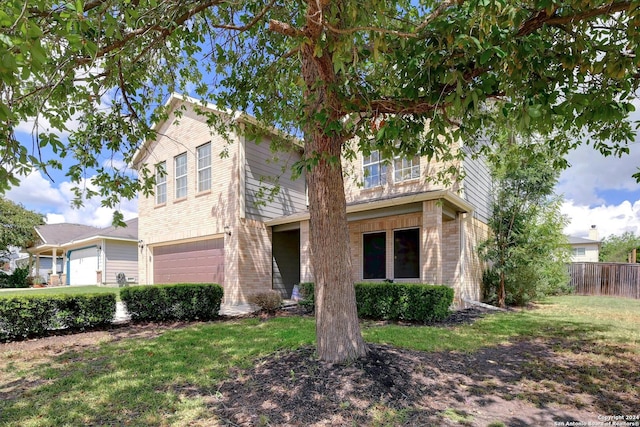 view of front of home featuring a front yard and a garage