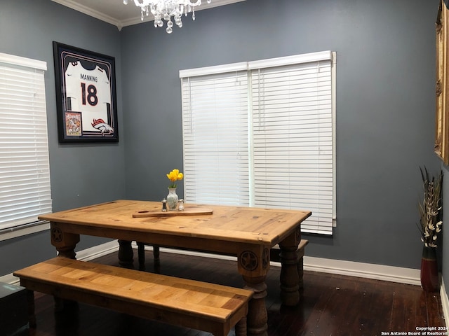 dining area with an inviting chandelier, crown molding, baseboards, and dark wood-style flooring