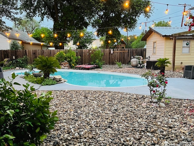 view of swimming pool featuring a patio area, central air condition unit, a fenced in pool, and a fenced backyard