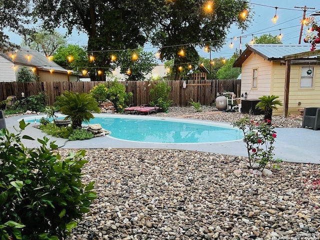 view of swimming pool featuring central air condition unit, a fenced in pool, a patio, and a fenced backyard