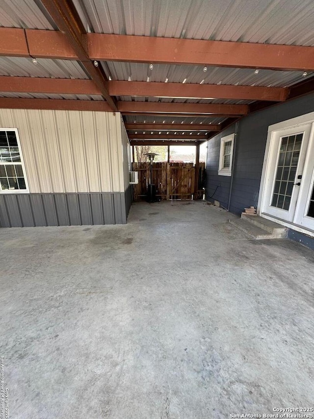 view of patio featuring a carport and fence