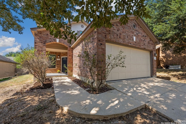 front facade featuring a balcony and a garage