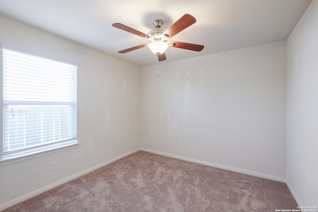 unfurnished room featuring light carpet and ceiling fan