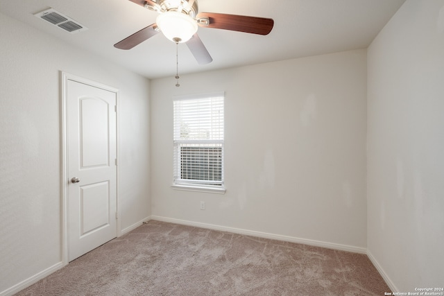 carpeted empty room featuring ceiling fan