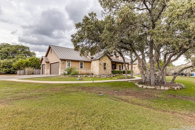 view of front of home with a front lawn and a garage