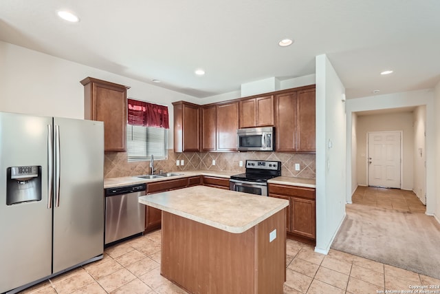 kitchen featuring a kitchen island, sink, light tile patterned floors, and stainless steel appliances