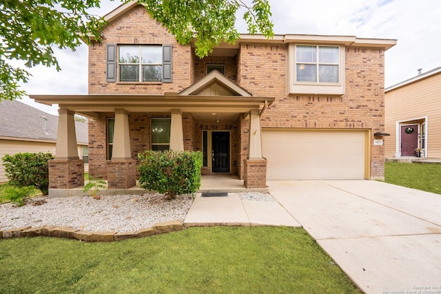 view of front of property with a front yard and a garage