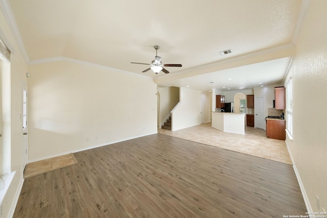 unfurnished living room with light hardwood / wood-style flooring, ceiling fan, and crown molding