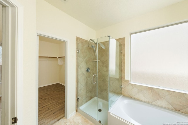 bathroom with hardwood / wood-style floors and plus walk in shower