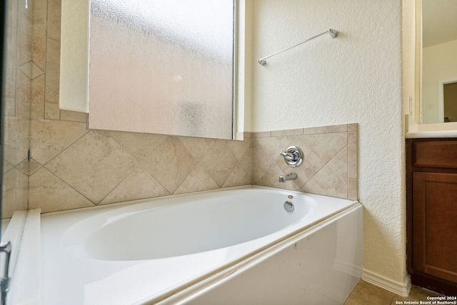 bathroom with vanity and a tub to relax in