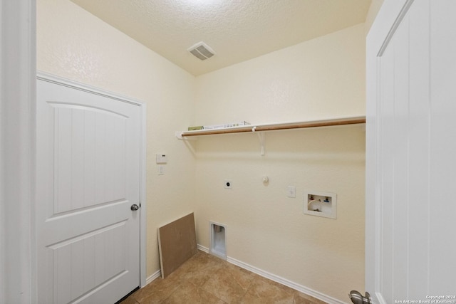 washroom featuring gas dryer hookup, hookup for an electric dryer, a textured ceiling, and hookup for a washing machine