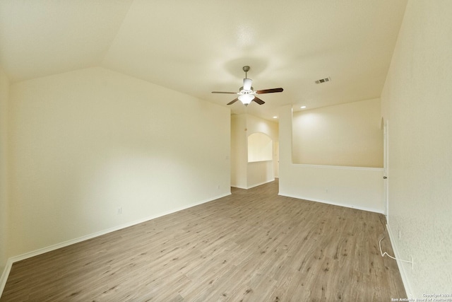 spare room featuring ceiling fan, vaulted ceiling, and light wood-type flooring