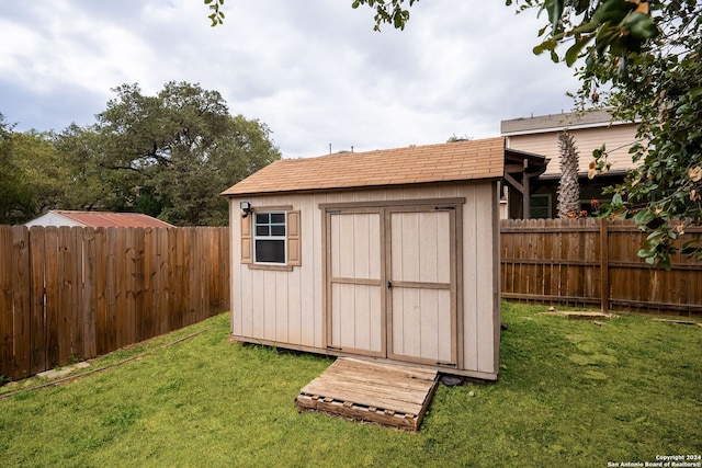 view of outbuilding featuring a lawn