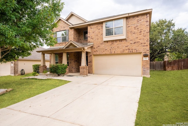 craftsman house featuring a front yard and a garage