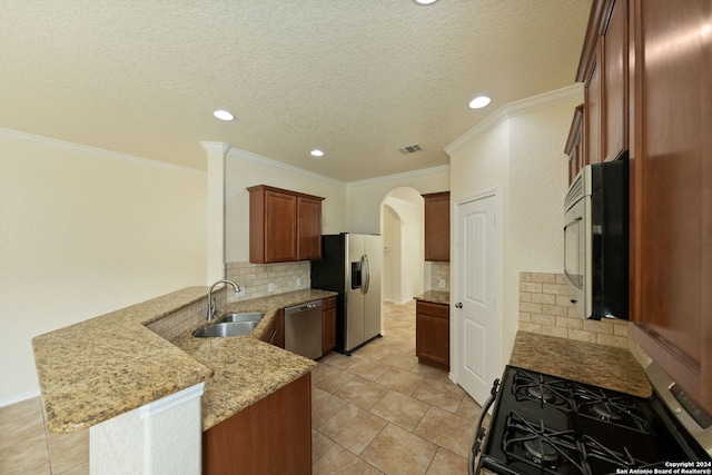 kitchen featuring light stone countertops, sink, backsplash, kitchen peninsula, and stainless steel appliances