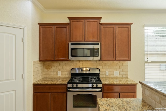 kitchen featuring light stone counters, stainless steel appliances, ornamental molding, and tasteful backsplash