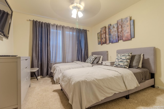 bedroom with light carpet and ceiling fan